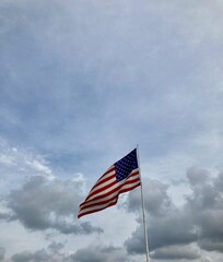 American flag against cloudy sky