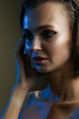 fashion portrait of young woman on dark background. girl with professional make up on brown background. studio beauty photo shoot of glamour model with perfect make up close up.