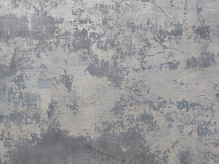 Old plastered wall, peeling light paint on cement, gray tone background