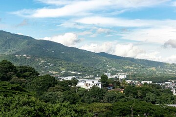 Fototapeta na wymiar Panoramic city landscape with blue sky. Escazu, San Jose, Costa Rica. 