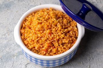 Traditional turkish bulgur pilaf with tomato sause in plate (Turkish name; meyhane pilavi)