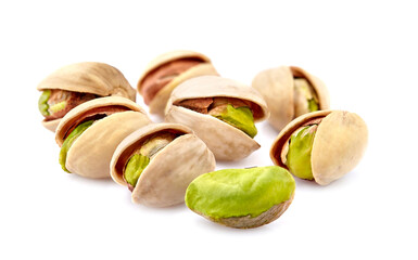 Pistachio nuts in closeup isolated on white background.