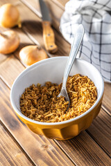 Pieces of fried onions in bowl.