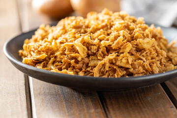Pieces of fried onions on plate.