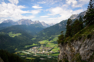 Werfen city landscape surrounded by nature and mountains with snowy peaks on a cloudy day, Werfen,...