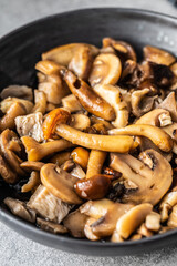 Sliced preserved mushrooms in bowl.