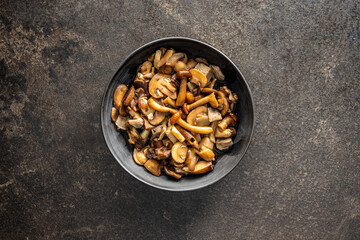 Sliced preserved mushrooms in bowl.