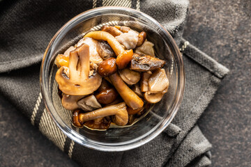 Sliced preserved mushrooms in bowl.