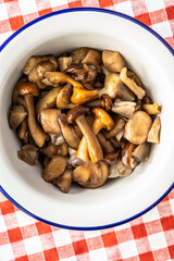 Sliced preserved mushrooms in bowl.