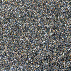 sea beach of small multi-colored pebbles as a natural background