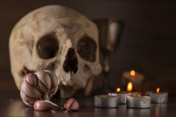 dead scene, hallowen night, skull, garlic and candles