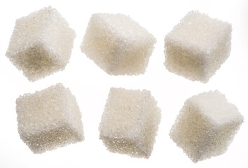 White sugar cubes on white background. Macro picture.