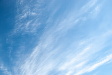 Blue sky background with tiny clouds.