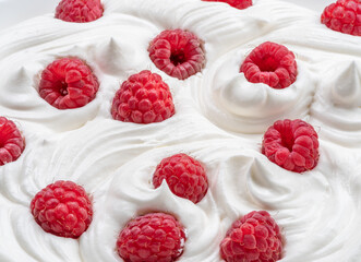 Fresh raspberries in the yoghurt or cream. Top view.