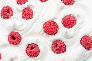 Fresh raspberries in the yoghurt or cream. Top view.
