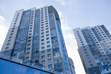 Obraz premium Tall buildings in the city against the blue sky, urban high-rise buildings.