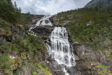 Fototapeta na wymiar Breathtaking scenery and four majestic waterfalls in Husedalen from Kinsarvik to the Hardangervidda mountain plateau, Norway