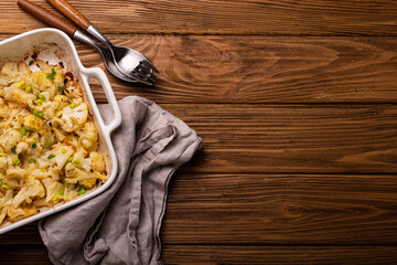 Baked cauliflower with herbs top view copy space