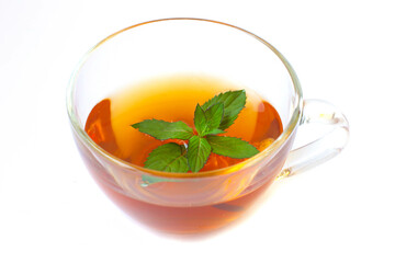 Transparent cup of tea with mint leaf isolated on white background