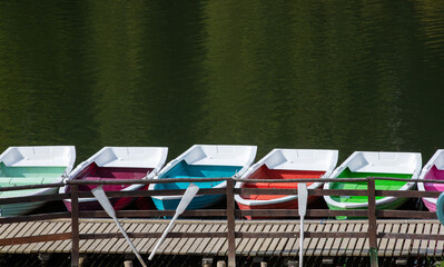 Fototapeta na wymiar many multicolored boats anchored on the shore