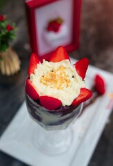 Açaí glass with milk cream and strawberries, Brazilian dessert, ice cream. flavors of the amazon