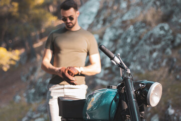 
a young biker about to ride his motorcycle.