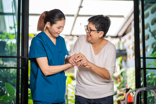 Nurses in nursing homes and care for the elderly by helping them walk, health care concepts, good health, sickness