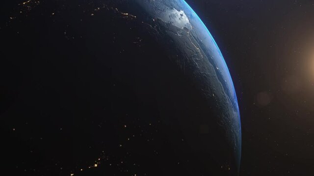 Amazing animation of the earth seen from space, on dark background with moving stars. Sun illuminating the earth. High quality 3D animation. 4K UHD.