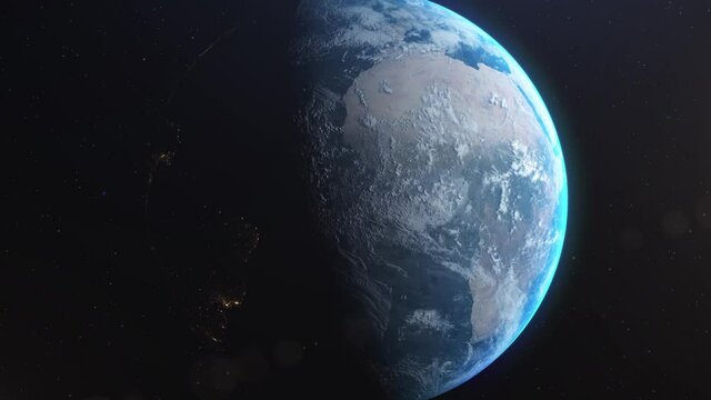 Amazing realistic animation of the earth seen from space, on dark background with moving stars. Sun illuminating the earth. High quality 3D animation. 4K UHD.