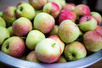 Many ripe red-green apples in bowl