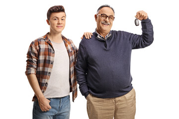 Father and son with a car key, smiling and looking at camera