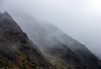 The slopes of a mountain in the fog