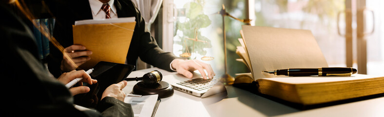 Business and lawyers discussing contract papers with brass scale on desk in office. Law, legal services, advice, justice and law concept picture with film grain effect