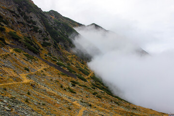 The slopes of a mountain in the fog