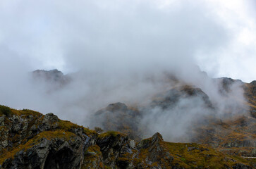 landscape with clouds on top of mountain ridges