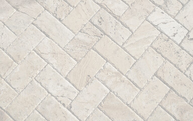 White brick pavers sidewalk background. Neutral texture of a flat brick wall close-up. 