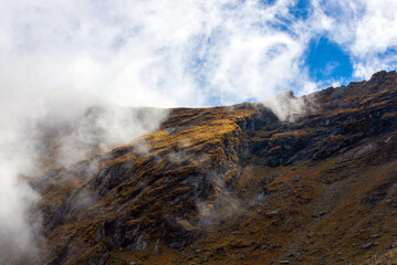 landscape with clouds on top of mountain ridges