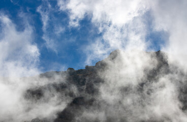 landscape with clouds on top of mountain ridges