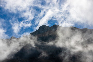 Landscape with clouds on mountain ridges