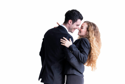 Happy caucasian man and woman couple in suit dancing isolated on white background. Professional successful couple embracing. Models in love, relationship, dating, flirting, lovers, romantic .