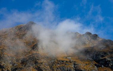 Landscape with clouds on mountain ridges