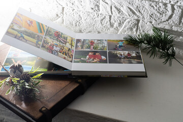 Luxury wooden photo book, wooden box with summer photos printed and flash card on linen natural background. Family memories photobook. Save your summer vacation memories. Photo album with wooden cover