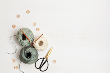 Craft hobby background with yarn in natural colors. Recomforting, destressing hobby for cold fall and winter weather. Mock up, copy space, top view