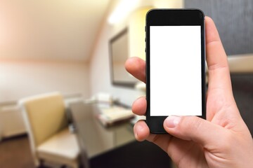 Human hand holding smartphone with white blank empty screen mockup, using smart at home