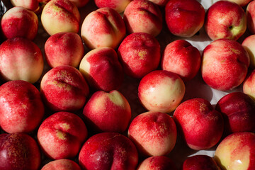 Beautiful ripe peaches and nectarines on the market counter. Great fruit background.