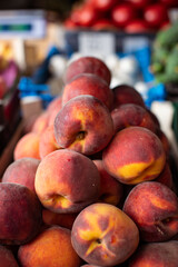 Beautiful ripe peaches and nectarines on the market counter. Great fruit background.
