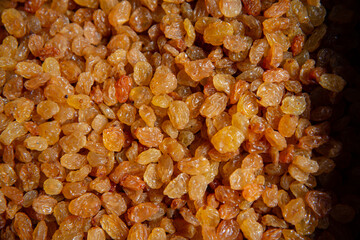 Beautiful raisins on the market counter. Dried fruits close-up.