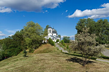 Autumn panorama of a part of a residential district neighborhood with a church with modern architecture and belfry,  Drujba, Sofia, Bulgaria 