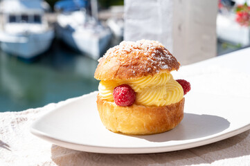 Tarte tropezienne or La Tarte de Saint-Tropez - dessert pastry consisting of filled brioche with cream and fresh berries.