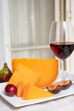 Cheese collection, French cheese mimolette made from cow milk served with fresh figs and red wine